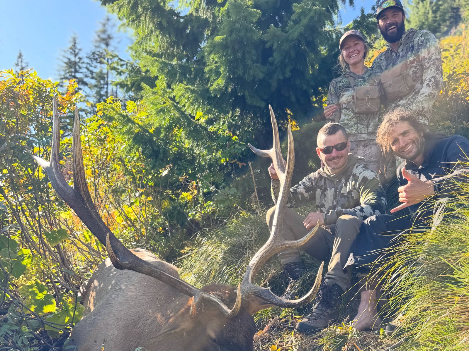 Tucker Lehr and Karissa Mielke with hunters and a bull elk